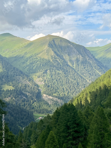 Summer landscape with mountains forests and cloudy sky in Alpes. Austria. Tranquility. Beauty and tranquility in farming. Natural and healthy living in a village. 