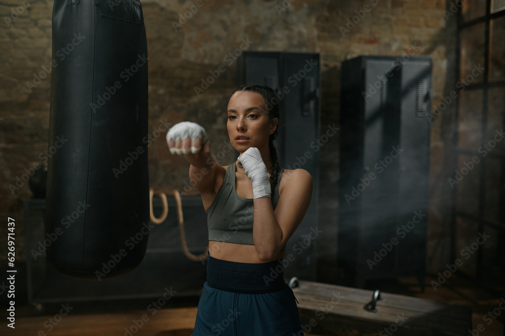 Front view portrait of powerful woman boxer fighting to camera