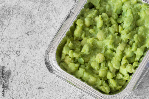 Quadro em tela Mushy peas in a takeaway foil tray carton container