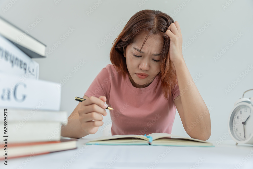 Asian student woman have anxiety because of exams, female prepare for test and learning lessons in the library. stress, despair, haste, misunderstanding reading, discouraged, expectation, knowledge Asian student woman have anxiety because of exams, female prepare for test and learning lessons in the library. stress, despair, haste, misunderstanding reading, discouraged, expectation, knowledge