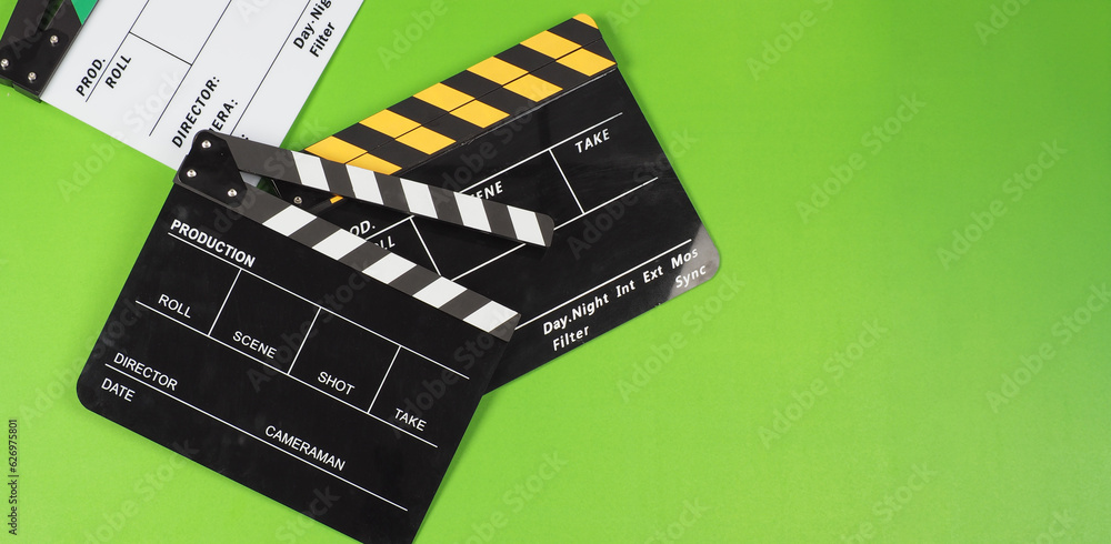Three clapper boards or movie slate on the green screen background floor.