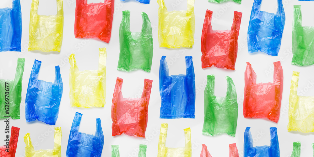 Top view pattern from colored plastic bags, wide banner. Single-use empty polythene packet, Eco trend to reduce disposable plastics, Biodegradable packaging waste, creative pattern, design Top view pattern from colored plastic bags, wide banner. Single-use empty polythene packet, Eco trend to reduce disposable plastics, Biodegradable packaging waste, creative pattern, design