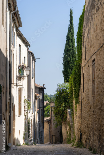 Fototapeta Naklejka Na Ścianę i Meble -  Vertical landscape view of old narrow street in the quaint historic city center of Montpellier, France in summer