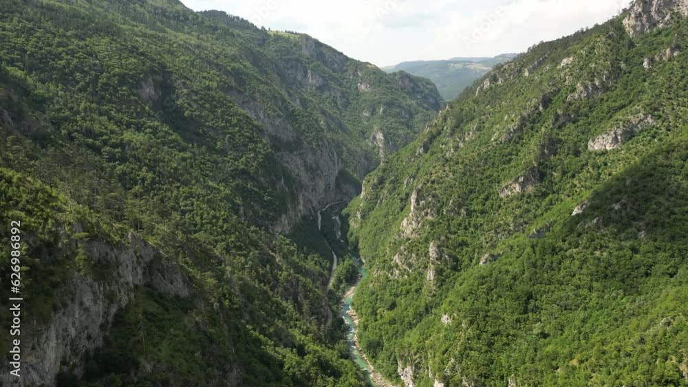 The drone flies over a huge, deep canyon, flanked by green mountains and rocks. Canyon of the Tara River. Montenegro. Aerial view. The drone flies over a huge, deep canyon, flanked by green mountains and rocks. Canyon of the Tara River. Montenegro. Aerial view.
