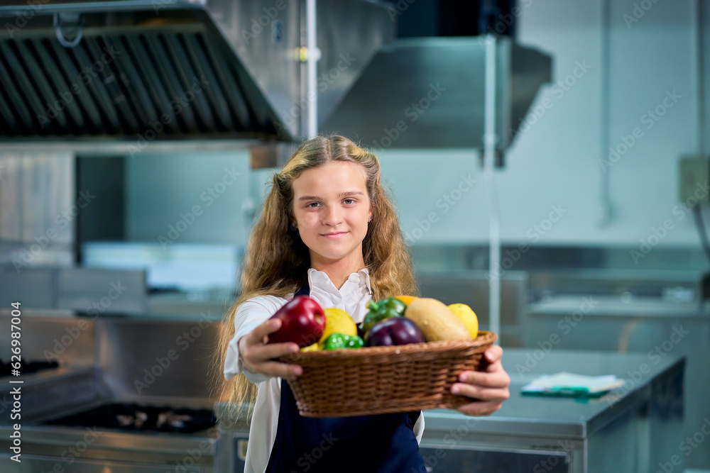 Single young girl in chef uniform portrait standing and give fruit basket to you in real kitchen for education kitchen class concept.