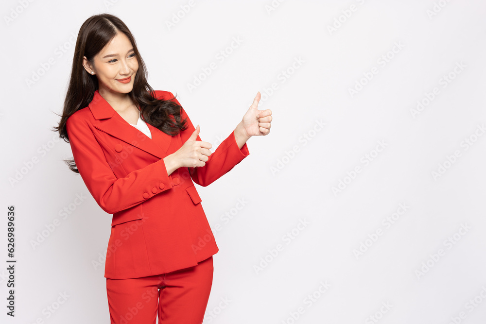 Young Asian business woman in red suit showing thumbs up isolated on white background Young Asian business woman in red suit showing thumbs up isolated on white background