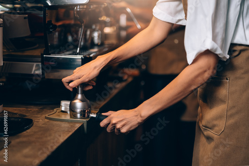 Professional Female Barista Preparing Coffee Powder For Brewing to Make Espresso Shot in Cafe. Small Business Entrepreneur Making Coffee in Her Shop.