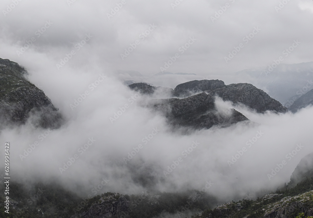 tops of the mountains are covered with clouds. Beautiful mountain view in Norway