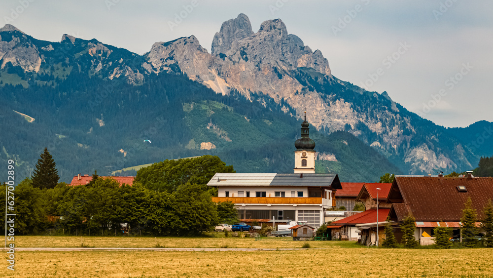 Obraz premium Alpine summer view with a church near Tannheim, Tannheimer Tal valley, Reutte, Tyrol, Austria