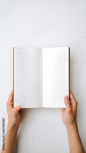 Wallpaper Mural Hand holding blank white book, white background, flat lay Torontodigital.ca