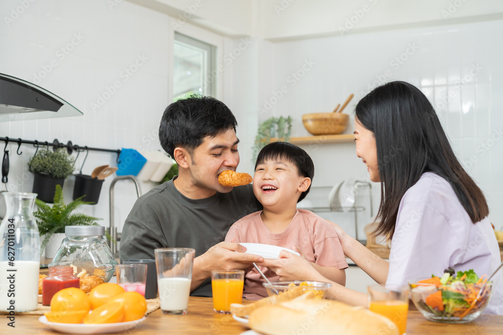 Happy refreshment family breakfast in morning, asian young parent father, mother and little cute boy, child having meal in kitchen eating together at home. Cheerful, enjoy cooking people. Happy refreshment family breakfast in morning, asian young parent father, mother and little cute boy, child having meal in kitchen eating together at home. Cheerful, enjoy cooking people.