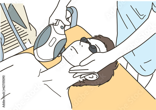 ヒゲの脱毛の施術を受ける若い男性
