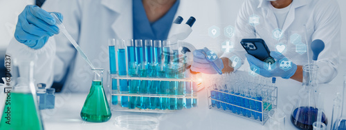 Professional scientist looking through a microscope in a laboratory with blood samples or tests, Science, analysis and medical technology concept.