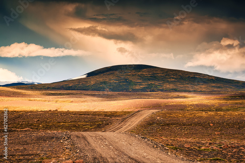 Dirt road through volcanic mountain in remote wilderness on rural scene