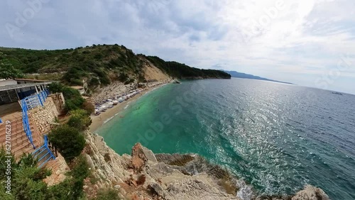 drone view of Pulebardha beach. Pulebardha is a small, secluded beach located near the town of Saranda in Albania. It is known for its clear turquoise waters, white pebbled beach, and dramatic cliffs. photo