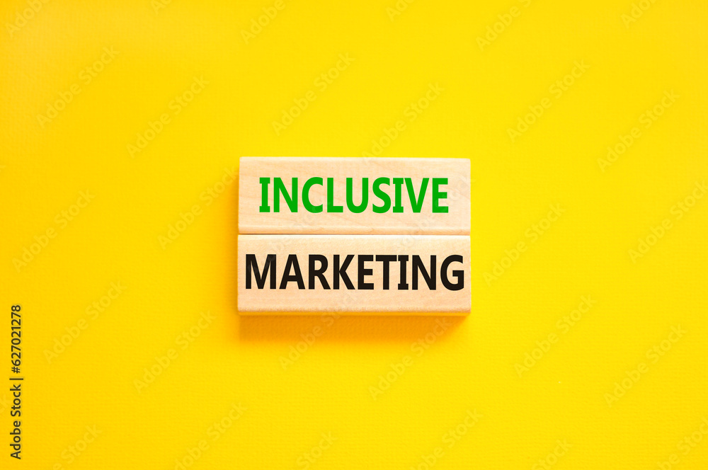 Inclusive marketing symbol. Concept words Inclusive marketing on beautiful wooden block. Beautiful yellow table yellow background. Business inclusive marketing concept. Copy space.