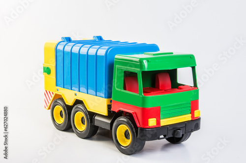 Multi-colored plastic toy trucks for children's games on a white background. Garbage truck. © baxys