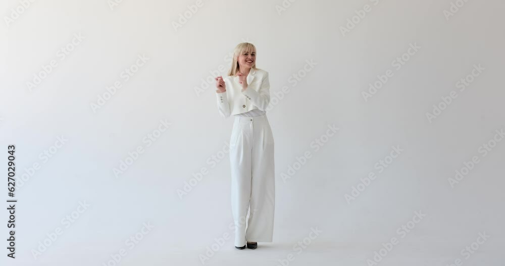 A captivating and attractive woman is seen on a clean white backdrop, dancing with vibrant energy. Her graceful movements and alluring presence captivate the viewer's attention. A captivating and attractive woman is seen on a clean white backdrop, dancing with vibrant energy. Her graceful movements and alluring presence captivate the viewer's attention.