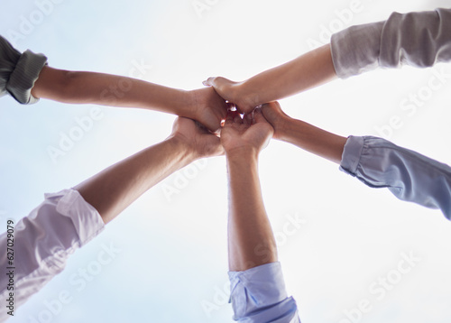 Team building, hands and people high five in collaboration, support and circle of trust for motivation from below. Closeup, group and helping hand for success, mission and celebration of cooperation
