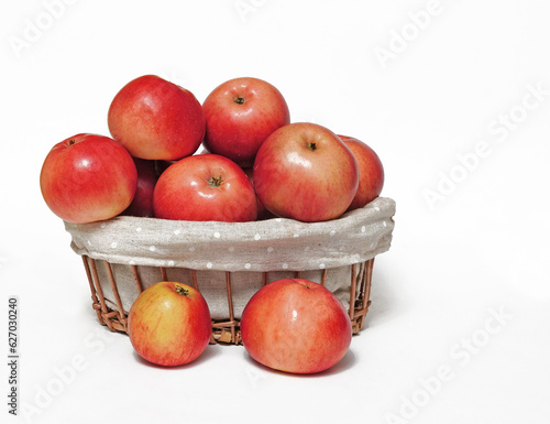 On an isolated white background  a basket with natural  ripe  red apples for healthy food advertising