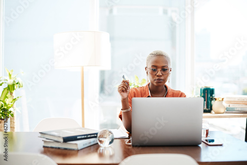 The most effective way to do it is simply to do it. Shot of a young businesswoman wearing earphones while working on a laptop in an office.