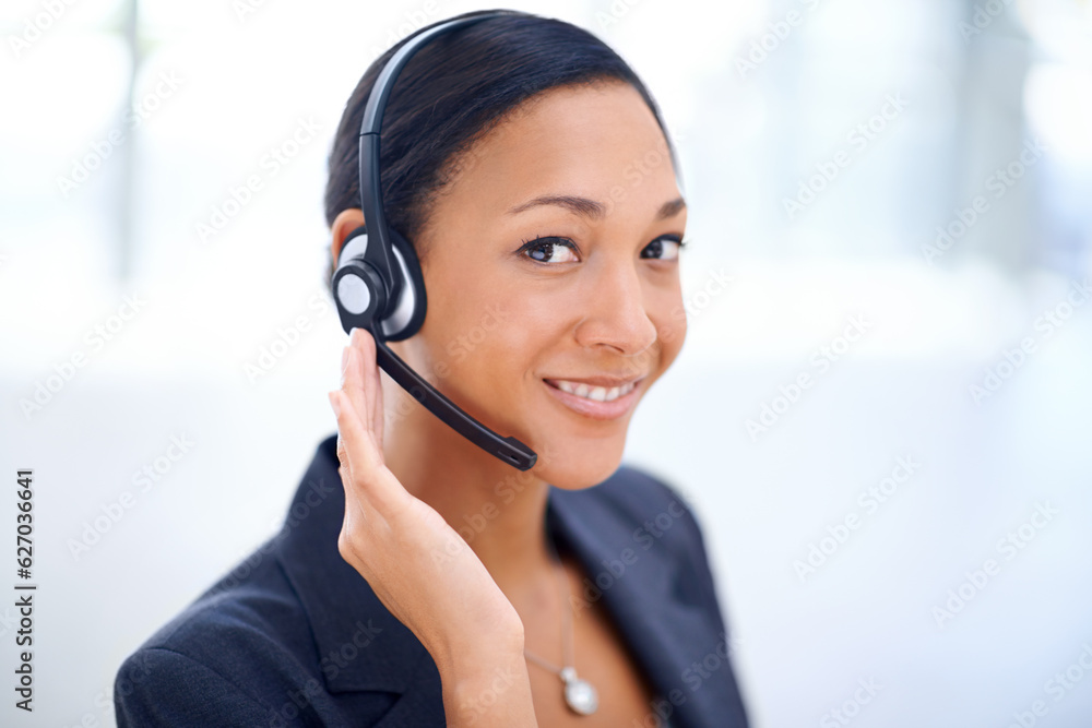 Service with a smile. An attractive call centre operator smiling at the camera. Service with a smile. An attractive call centre operator smiling at the camera.