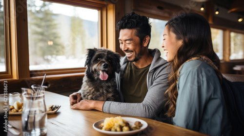 Cheerful young Asian couple and their pet dog delighting in a meal at a cozy, pet-friendly café, invoking a fun atmosphere. Generative AI