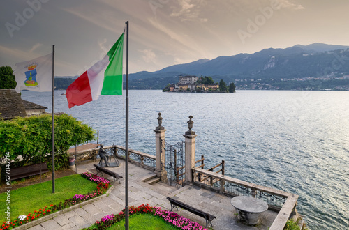 Aerial view of a beautiful mountain lake Orta with Italian flag in foreground