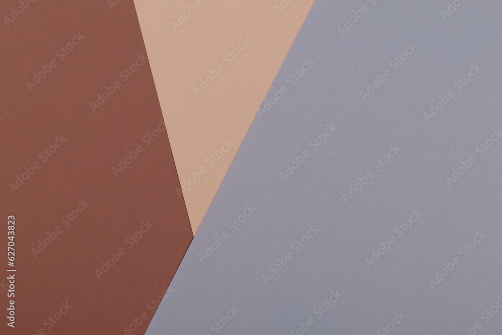 Multicolor background from a paper of different shades of brown and gray. Geometric backdrop. Multicolor background from a paper of different shades of brown and gray. Geometric backdrop.