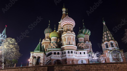 Back side of St. Basils cathedral with colorful domes illuminated at night from Red Square timelapse hyperlapse in Moscow, Russia