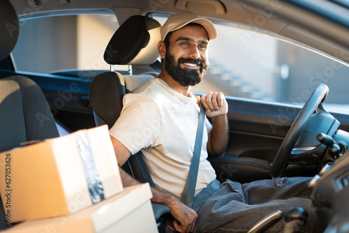 Print op canvas Arab Guy Putting Seat Belt In Car Working As Courier