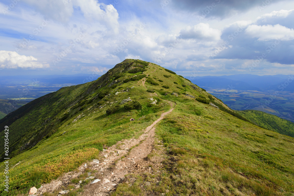 Mladky, Western Tatras, Slovakia. Mountain landscape in summer during sunny day. Footpath leading to the top of and peak of mountain. Wide angle with distorted corners.