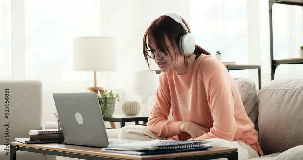 A smiling teenage girl embraces the use of her laptop for a video call, radiating happiness as she connects with someone through the virtual medium. With a joyful expression and a relaxed demeanor. A smiling teenage girl embraces the use of her laptop for a video call, radiating happiness as she connects with someone through the virtual medium. With a joyful expression and a relaxed demeanor.