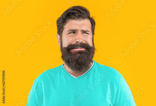 portrait of crying bearded guy on background. portrait of bearded guy.