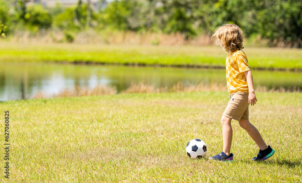 child enjoying childhood adventures outdoor. child playing football during childhood. Childhood memories of child boy. child while playing soccer football. Outdoor summer activity, copy space banner child enjoying childhood adventures outdoor. child playing football during childhood. Childhood memories of child boy. child while playing soccer football. Outdoor summer activity, copy space banner