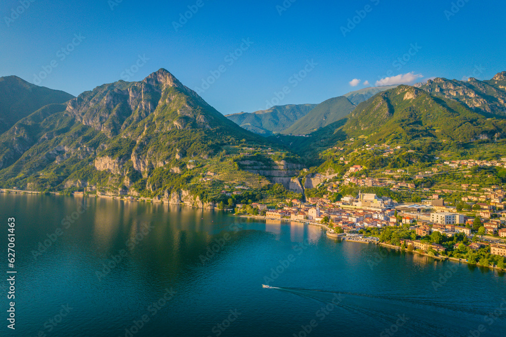 Marone, Lake Iseo. Aerial panoramic sunset view of Marone town surrounded by mountains and located in Iseo Lake, Brescia, Lombardy, Italy
