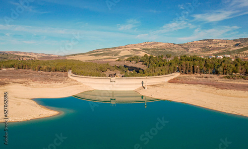 Drought in the reservoir. Very low water reserves due to the effects of climate change. Aerial view. Empty reservoir. Granada. Spain.