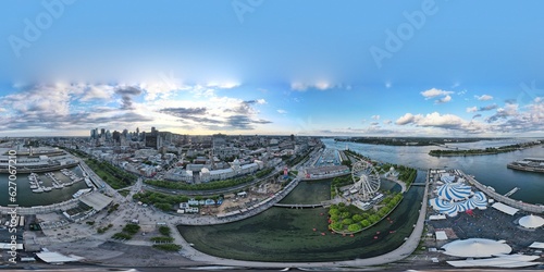 360 aerial photo taken with drone of the Ferris Wheel (La Grande Roue), the Cirque du Soleil tents, and Old Port next to the Saint Lawrence River in Montreal, Canada