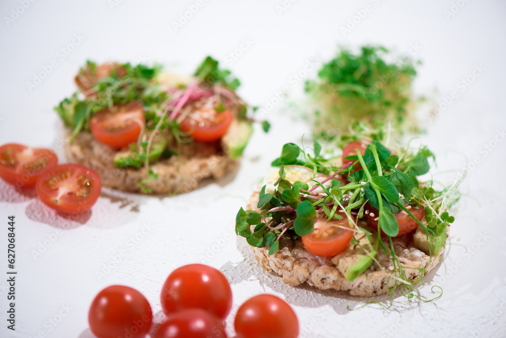 Toasts with microgreens. Hand holds a healthy toast. Healthy food concept. Super food. Toasts with microgreens. Hand holds a healthy toast. Healthy food concept. Super food.