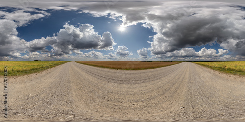 360 hdri panorama on white sand gravel road with clouds on blue sky in equirectangular spherical seamless projection, skydome replacement in drone panoramas, game development sky dome or VR content
