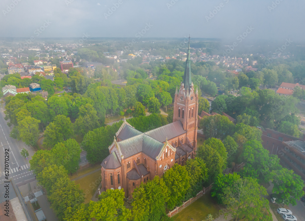 Church of Saint Marie in haze in Palanga, Lithuania. Aerial view on a foggy day. Low clouds over the city