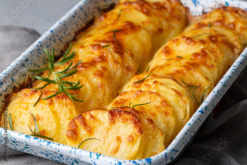 Potato gratin - graten (baked potatoes with cream and cheese) with rosemary and forks (Turkish name; Kremali patates) photo