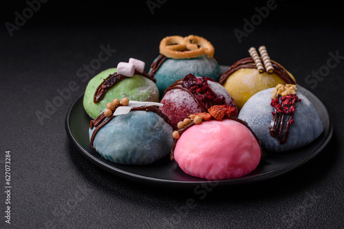 Delicious sweet colorful mochi desserts or ice cream with rice dough and toppings photo