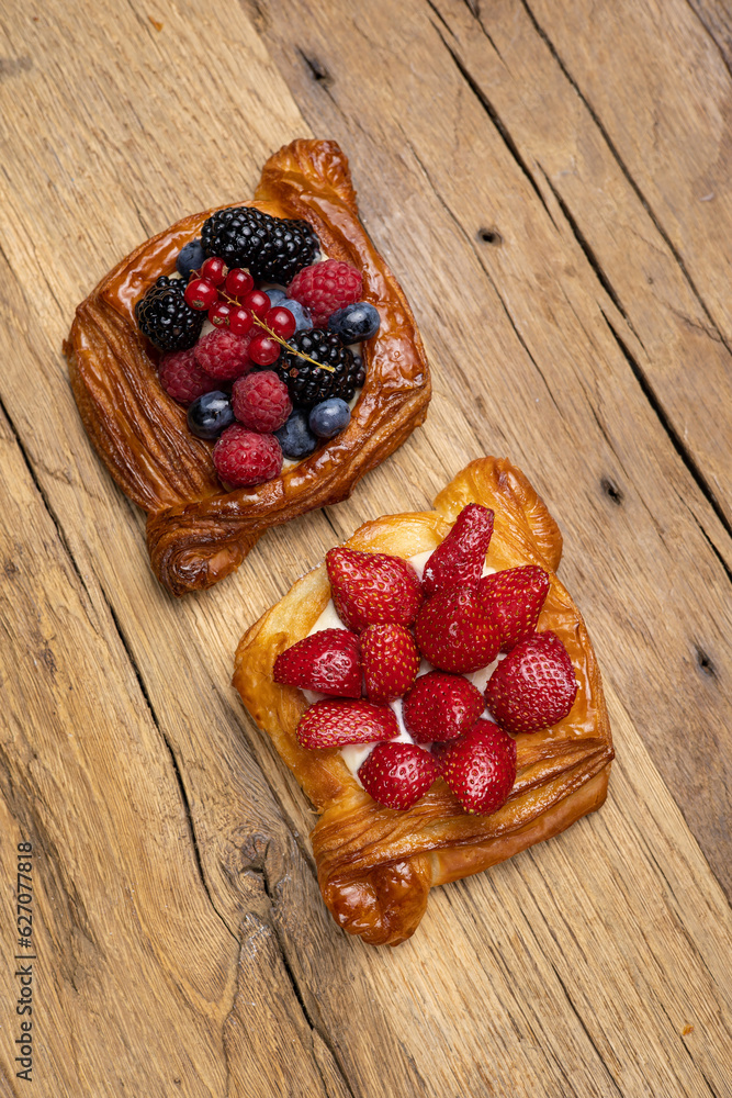 Delicious flavored pastries on a wooden table. Close up Delicious flavored pastries on a wooden table. Close up