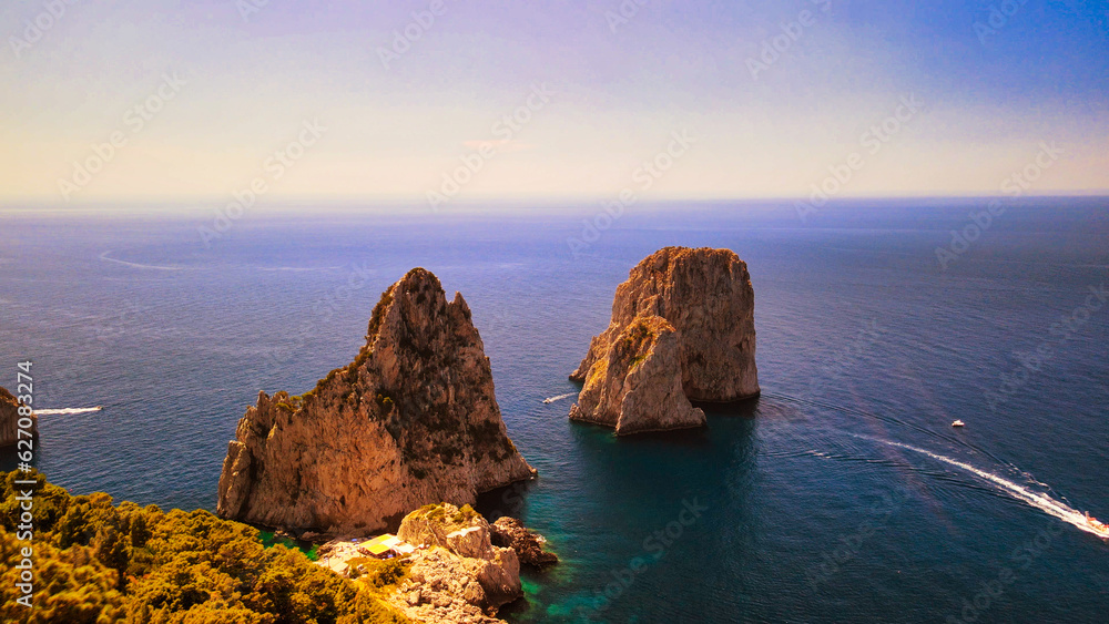 Amazing aerial view of Faraglioni in summer season. Rock natural formations in Capri Island, Italy Amazing aerial view of Faraglioni in summer season. Rock natural formations in Capri Island, Italy