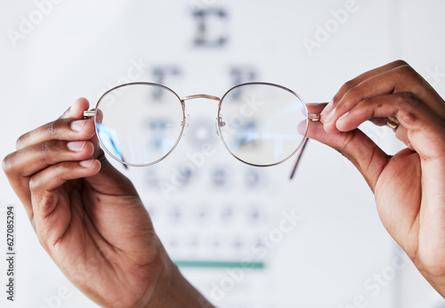 Hands, person and optometrist with glasses for vision, eye care and eyesight prescription. Closeup of optician, doctor and lens frame for eyewear, test and consulting of optical healthcare assessment