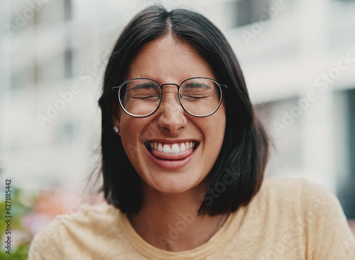 A little bit of fun never hurt anyone. Cropped shot of an attractive young businesswoman sitting alone outside and feeling playful while making a face.