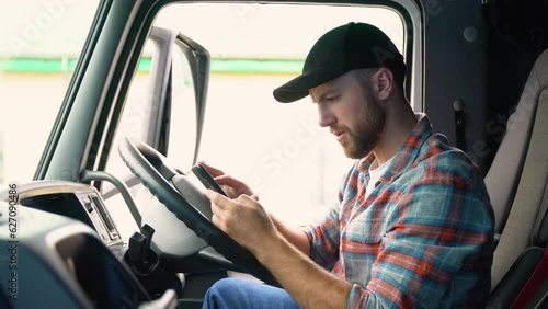 Professional trucker using truck gps navigation to transport and deliver goods to the destination. Transportation services. Right hand drive car photo