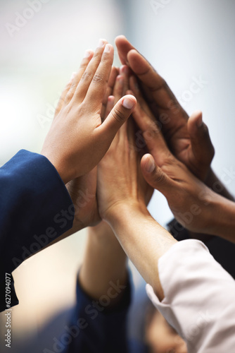 High five  celebration and hands of business people for team building  meeting or collaboration. Unity  diversity and closeup of group of employees with success  achievement or teamwork to celebrate.