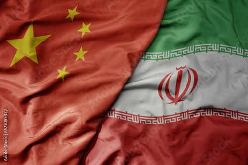 big waving national colorful flag of china and national flag of iran .